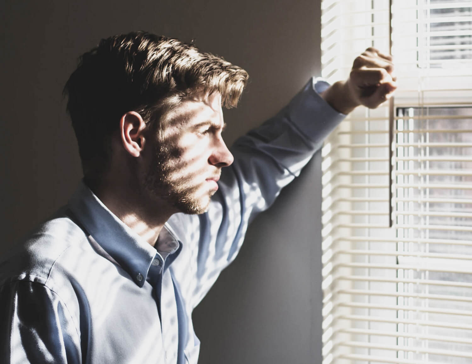 man looking out of window