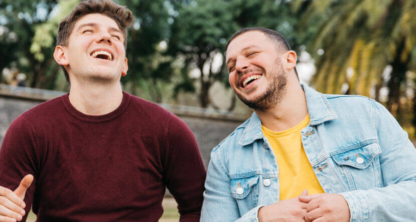 Men smiling outside at Extra Mile inpatient program