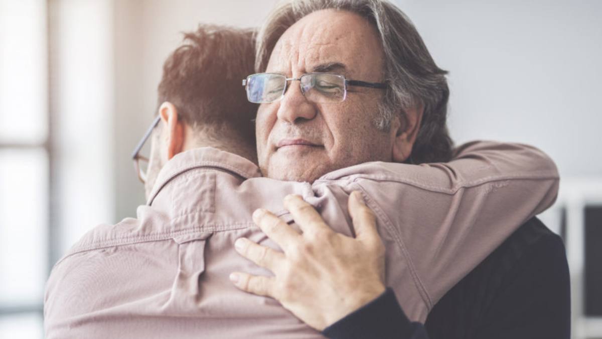 A son hugging his father and repairing relationships in recovery.