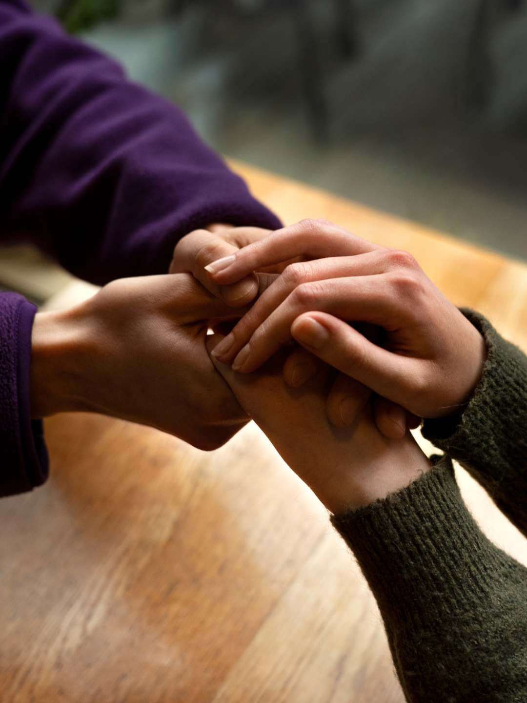 individuals supporting each other with hand holding.