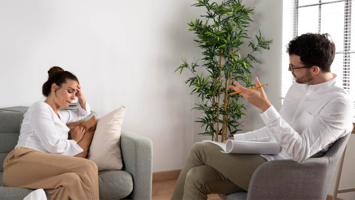 Woman receiving advice on coping with an alcoholic spouse during therapy.