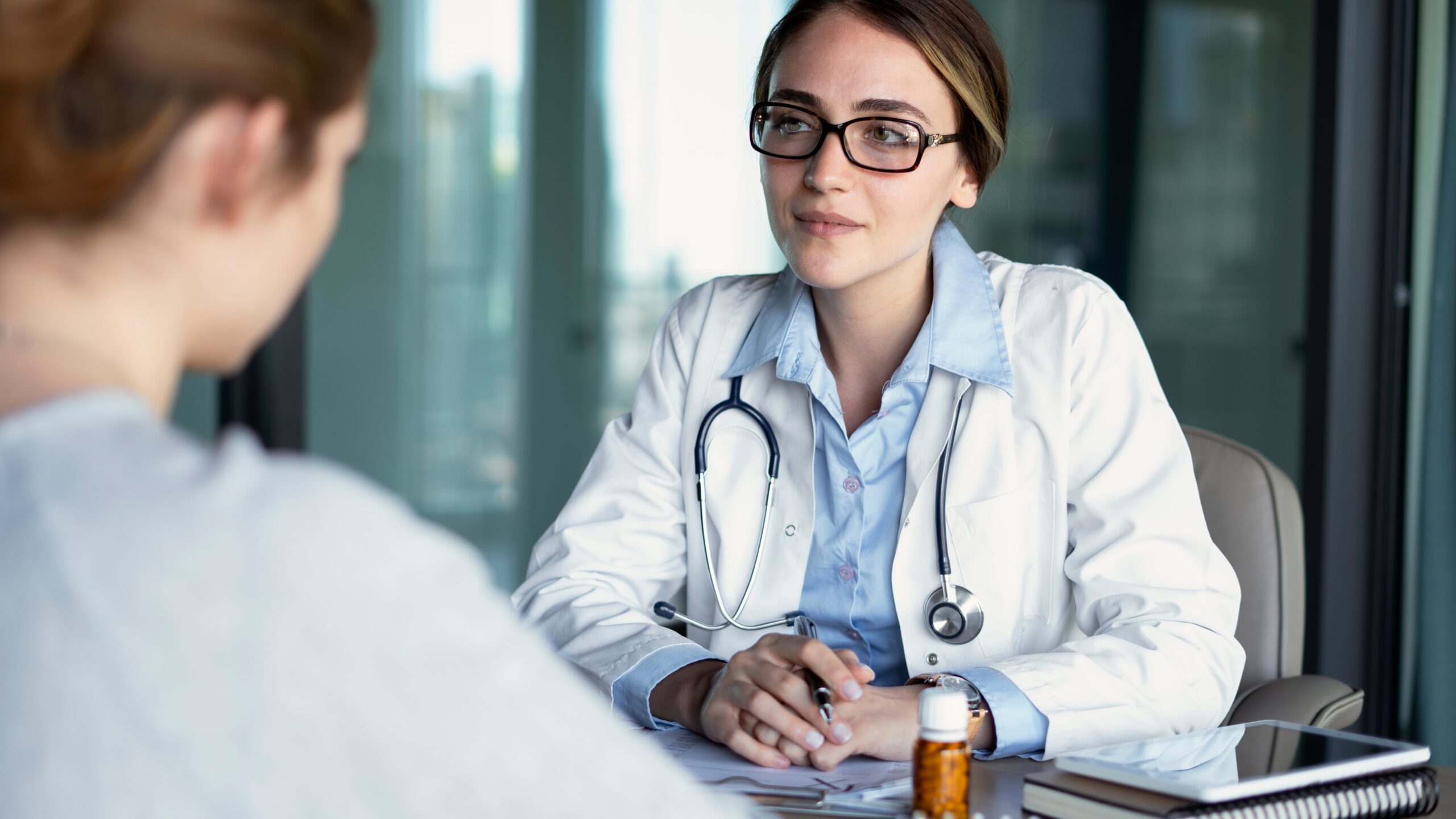 A woman discusses treatment options with her doctor during medication management in Mississippi