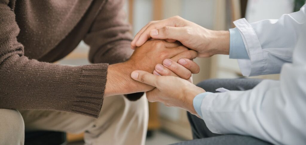 Therapist offers emotional support to a man struggling with anxiety and addiction.