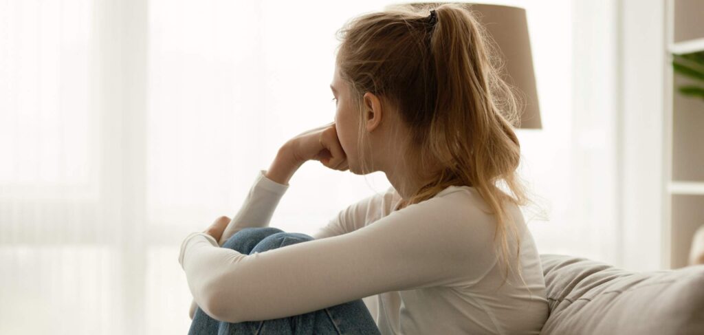 Woman coping with hydrocodone addiction symptoms.