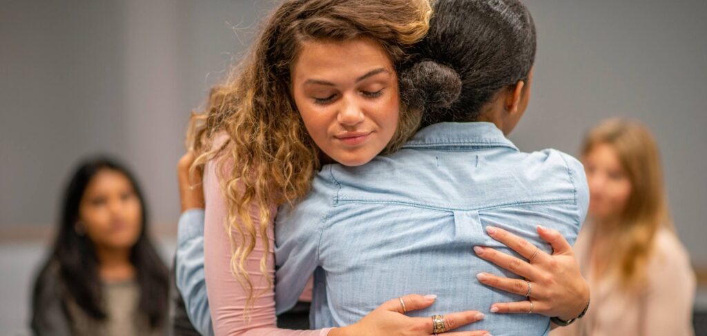 Woman supporting a loved one with addiction by attending an Al-Anon meeting.