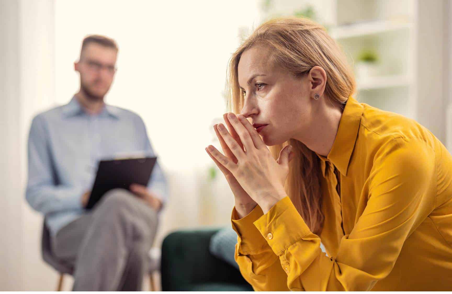 Woman working with a psychologist for trauma and addiction treatment.