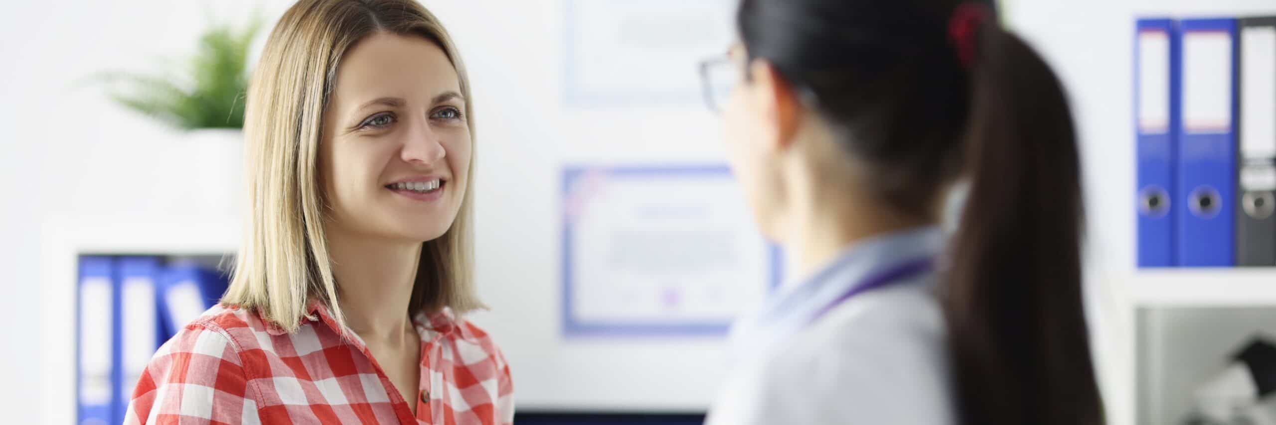 A woman talks to her doctor about detox options during recovery treatment.