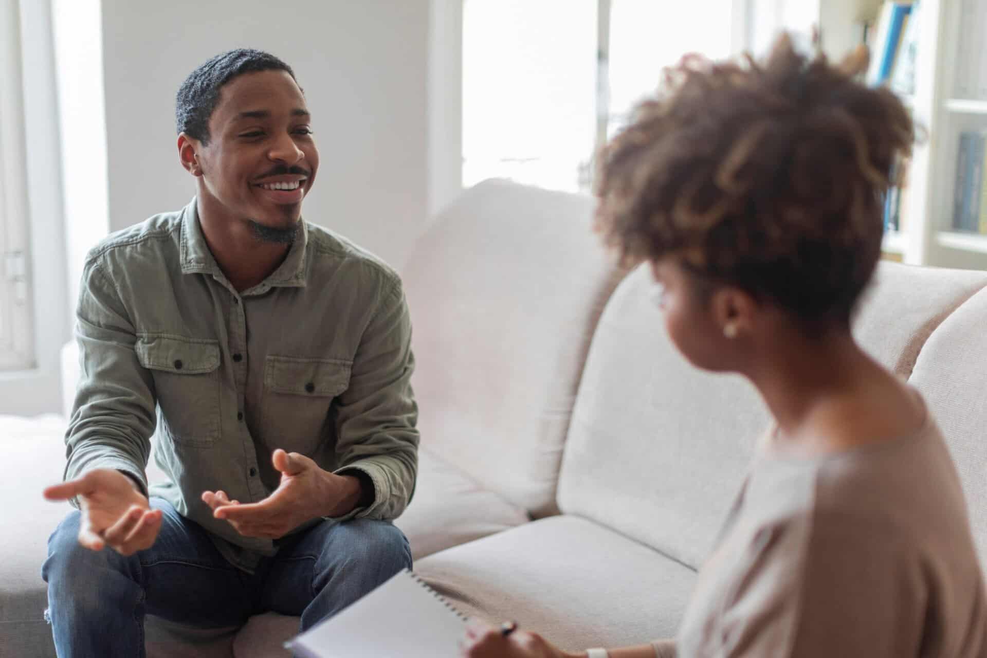 A man talks to his therapist about stress management in recovery.