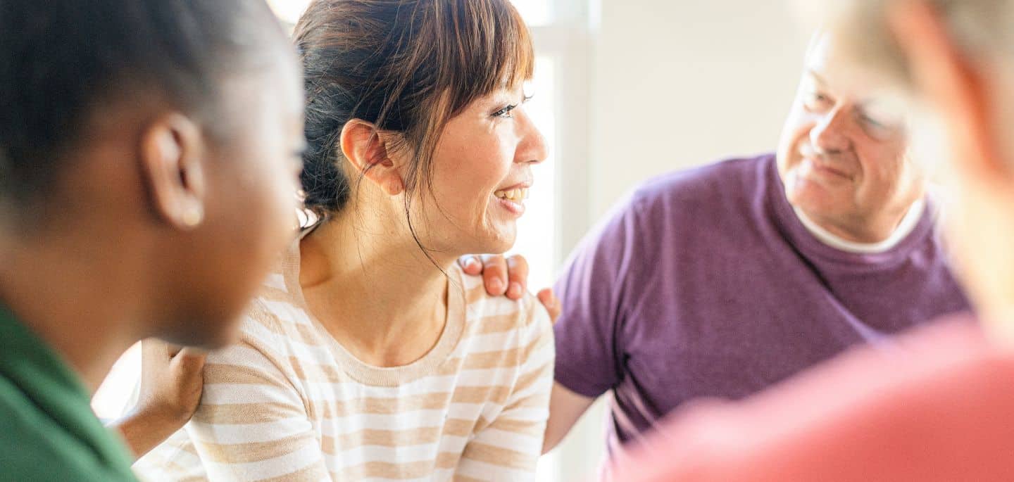 Woman receiving peer support in group therapy during medical detox in Mississippi.