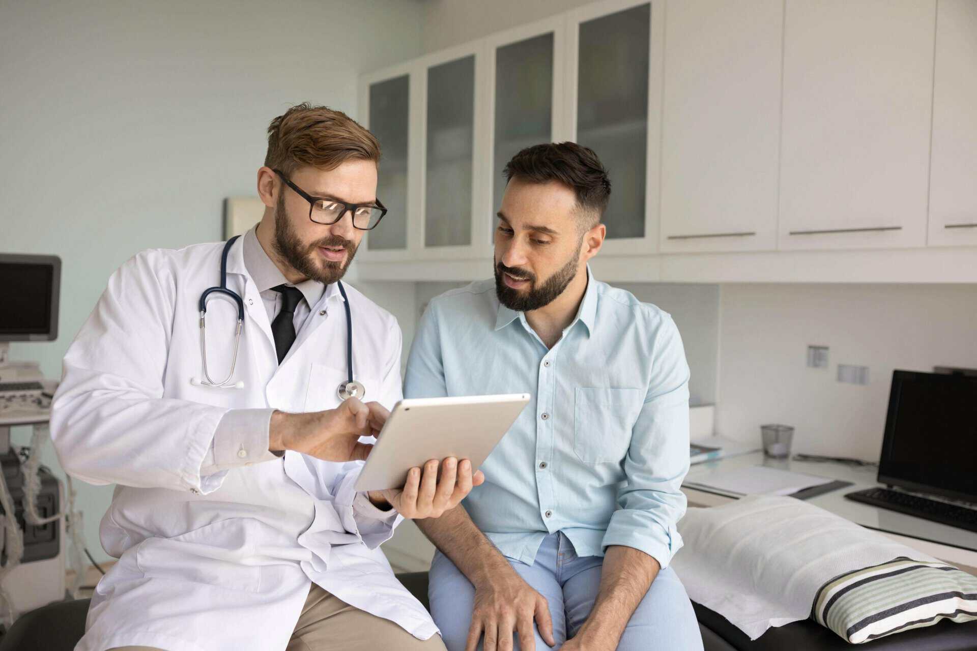 Doctor reviewing a treatment plan on a tablet with a patient during kratom rehab in Mississippi at Extra Mile Recovery.