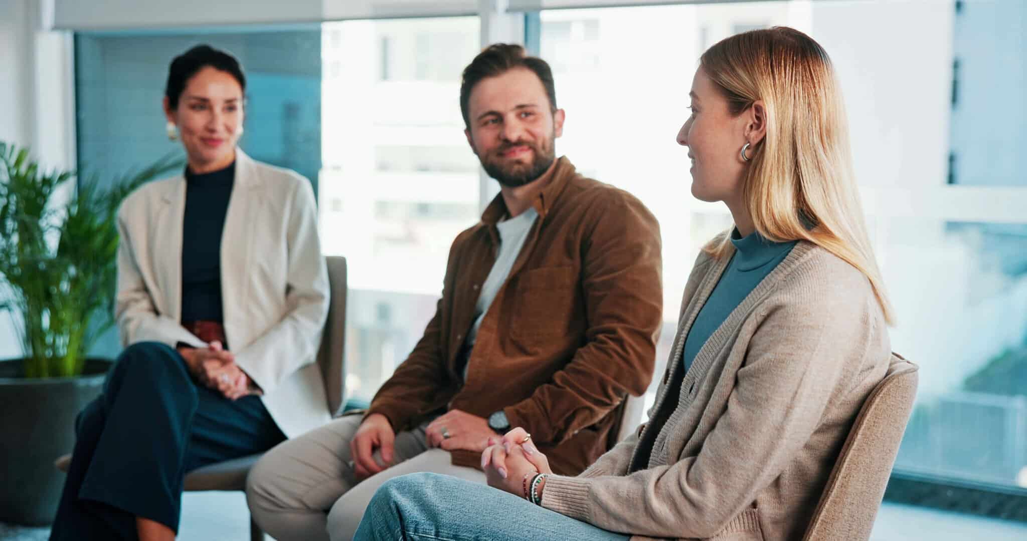 Woman speaking in a group therapy session about relapse triggers and why she can’t stay sober at Extra Mile Recovery.