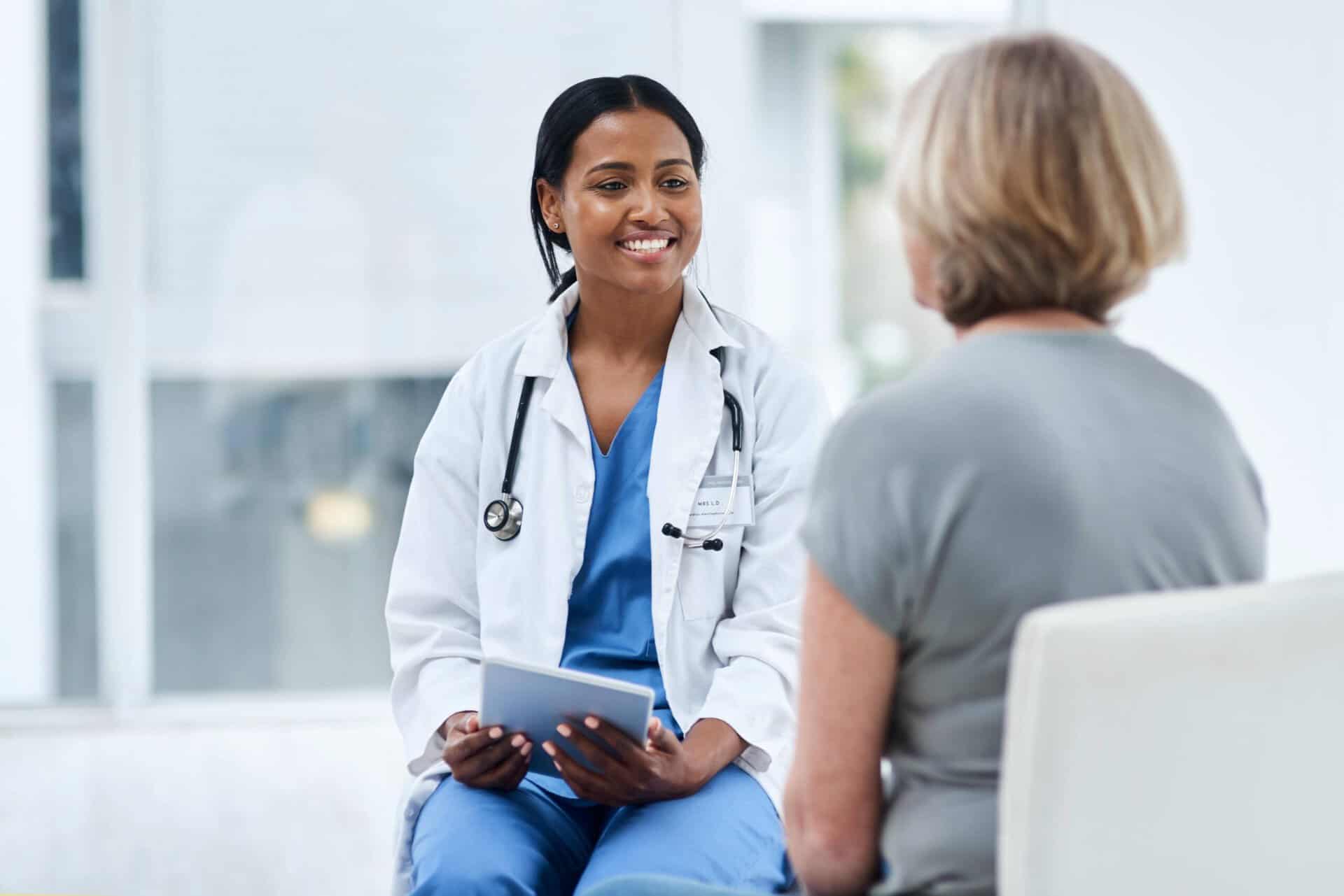 Female doctor reviewing treatment options on a tablet with a patient during kratom addiction treatment in Mississippi at Extra Mile Recovery.